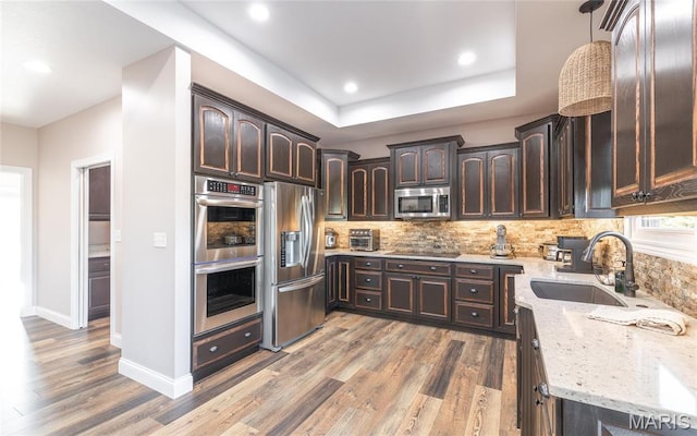 1100 Landon Rd, Bourbon, MO 65441 - kitchen featuring stainless steel appliances, dark brown cabinets, a sink, light stone counters, and recessed lighting
