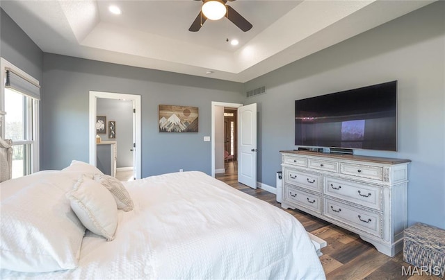1100 Landon Rd, Bourbon, MO 65441 - bedroom with a tray ceiling, dark wood-style flooring, baseboards, connected bathroom, and recessed lighting