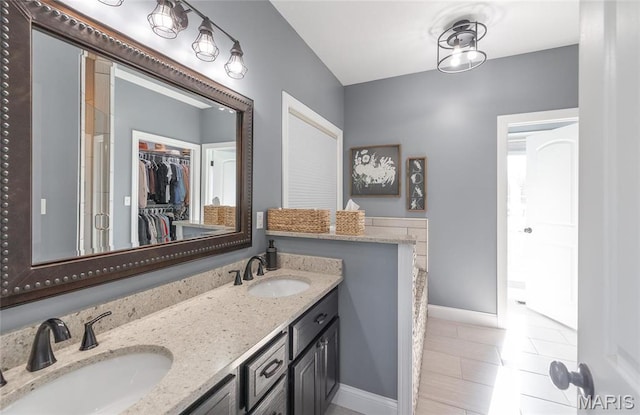 1100 Landon Rd, Bourbon, MO 65441 - full bath featuring baseboards, a spacious closet, double vanity, and a stall shower