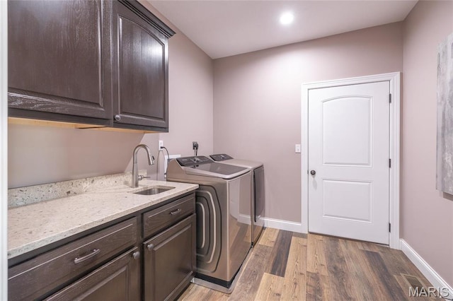 1100 Landon Rd, Bourbon, MO 65441 - laundry room with cabinet space, independent washer and dryer, light wood-style floors, baseboards, and recessed lighting