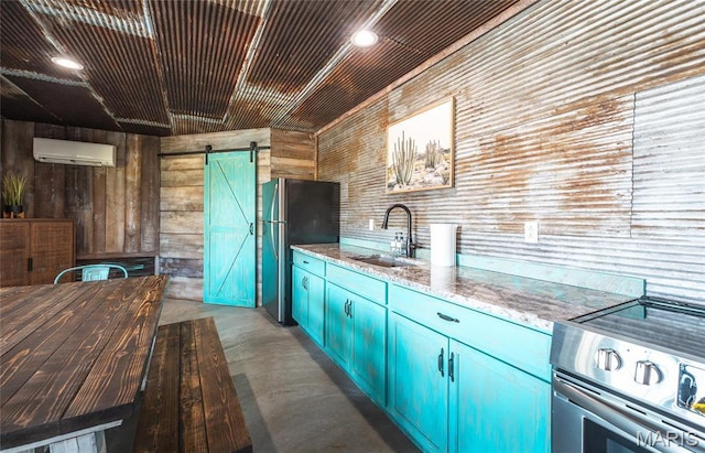 1100 Landon Rd, Bourbon, MO 65441 - kitchen with a sink, stainless steel appliances, a barn door, finished concrete floors, and blue cabinetry
