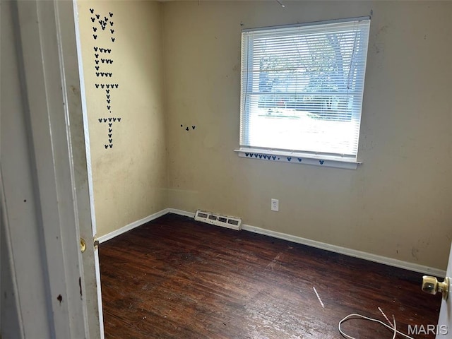 6016 Shillington Dr, Berkeley, MO 63134 - spare room featuring dark wood-style flooring and baseboards