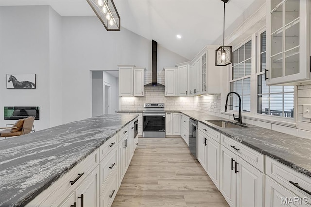 10102 Springer Dr, Bonne Terre, MO 63628 - kitchen with wall chimney range hood, stainless steel appliances, a sink, lofted ceiling, and dark stone counters