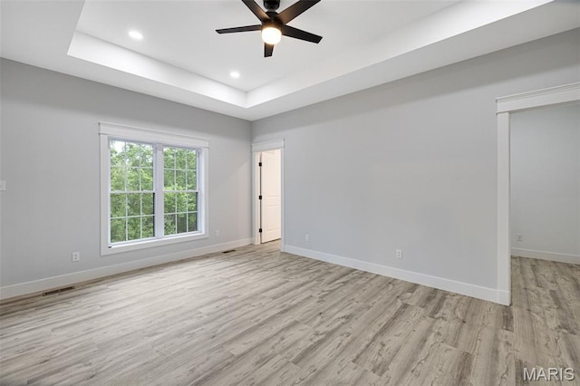 10102 Springer Dr, Bonne Terre, MO 63628 - empty room with ceiling fan, light wood-style flooring, baseboards, a tray ceiling, and recessed lighting