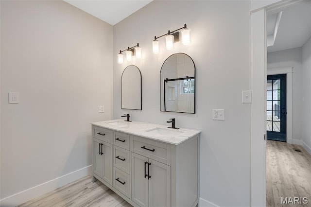 10102 Springer Dr, Bonne Terre, MO 63628 - bathroom with baseboards, wood finished floors, and double vanity