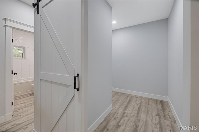 10102 Springer Dr, Bonne Terre, MO 63628 - hallway with a barn door, light wood-style flooring, baseboards, and recessed lighting