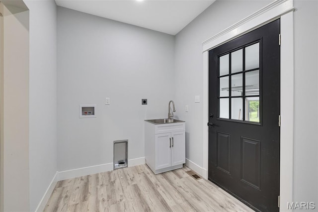 10102 Springer Dr, Bonne Terre, MO 63628 - laundry room with electric dryer hookup, cabinet space, washer hookup, light wood finished floors, and baseboards