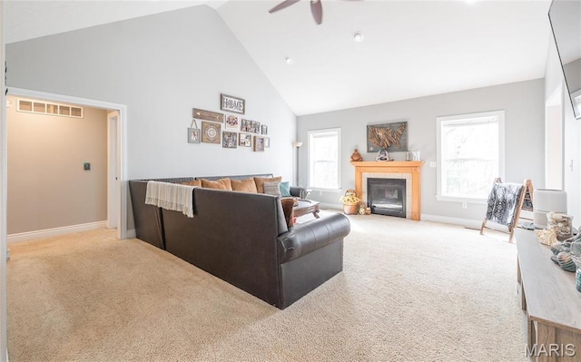 21438 Lancaster Ln, Waynesville, MO 65583 - living room with high vaulted ceiling, carpet, a ceiling fan, baseboards, and a tiled fireplace