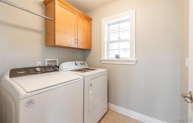 21438 Lancaster Ln, Waynesville, MO 65583 - laundry area featuring cabinet space, washing machine and clothes dryer, baseboards, and light tile patterned floors