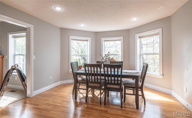 21438 Lancaster Ln, Waynesville, MO 65583 - dining space with light wood-style flooring, baseboards, healthy amount of natural light, recessed lighting, and a textured ceiling
