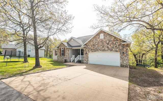 21438 Lancaster Ln, Waynesville, MO 65583 - view of front of home with stone siding, driveway, an attached garage, a front yard, and a trampoline