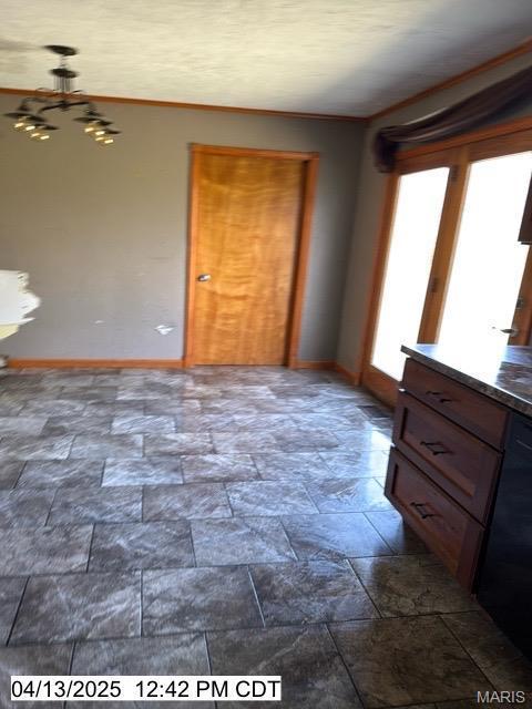 710 Ridgeway St, Hillsboro, IL 62049 - unfurnished bedroom featuring a chandelier, dark stone finish flooring, and baseboards
