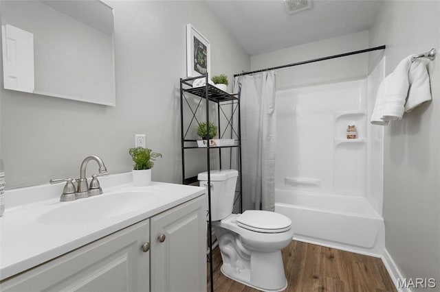 full bathroom with wood finished floors, toilet, vanity, and shower / tub combo with curtain