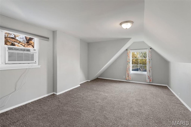 additional living space featuring carpet floors, lofted ceiling, cooling unit, and baseboards