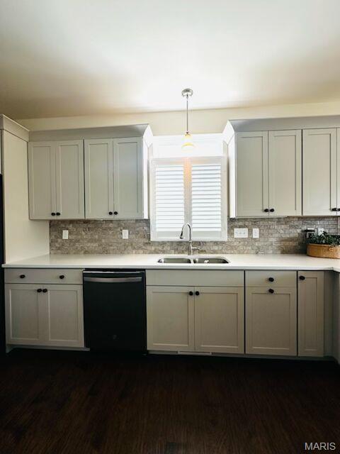 kitchen featuring dishwasher, a sink, and light countertops