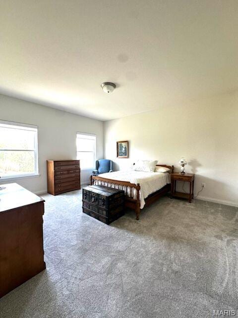 bedroom with carpet floors and baseboards