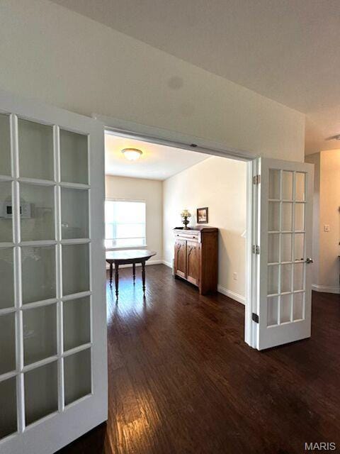 hallway with dark wood-style floors and baseboards