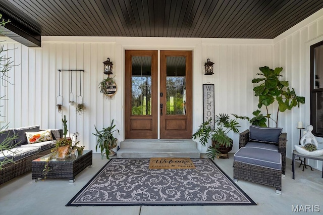 2509 Prairie Hollow Rd, Imperial, MO 63052 - property entrance with board and batten siding, an outdoor living space, and french doors