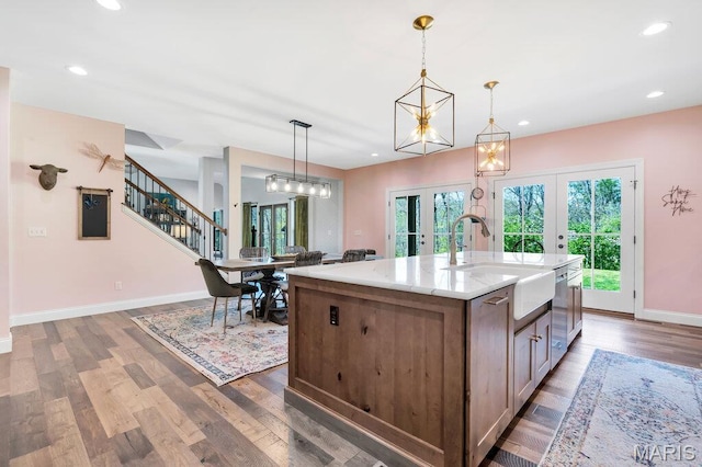 2509 Prairie Hollow Rd, Imperial, MO 63052 - kitchen with a sink, french doors, stainless steel dishwasher, an island with sink, and light stone countertops