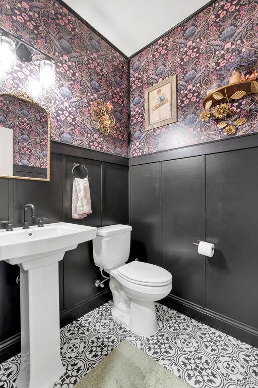 2509 Prairie Hollow Rd, Imperial, MO 63052 - half bathroom with toilet, a wainscoted wall, wallpapered walls, a decorative wall, and tile patterned flooring