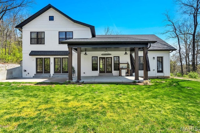 2509 Prairie Hollow Rd, Imperial, MO 63052 - rear view of property featuring roof with shingles, a patio area, and a lawn