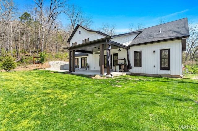 2509 Prairie Hollow Rd, Imperial, MO 63052 - rear view of property with a lawn, roof with shingles, and a patio area