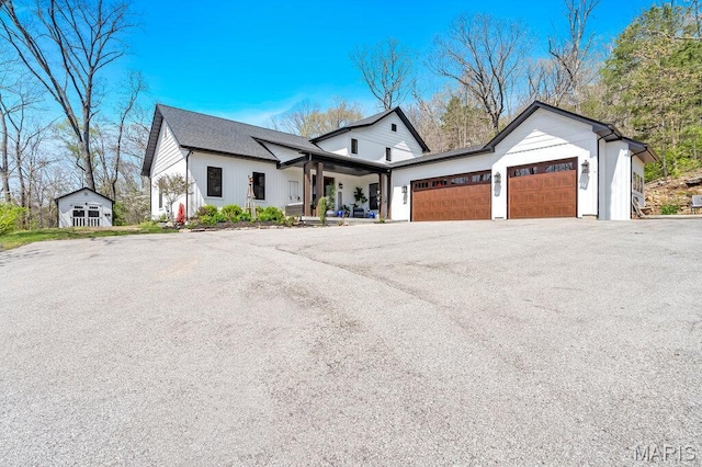 2509 Prairie Hollow Rd, Imperial, MO 63052 - modern inspired farmhouse featuring an attached garage, board and batten siding, and asphalt driveway