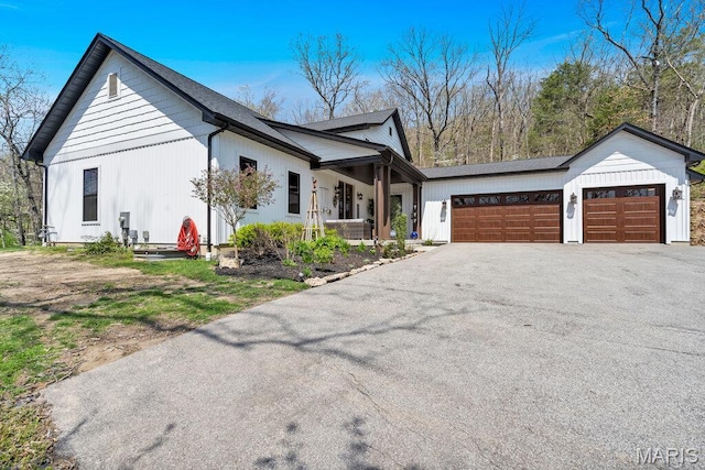 2509 Prairie Hollow Rd, Imperial, MO 63052 - modern farmhouse style home featuring an attached garage and asphalt driveway