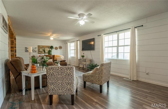 121 Ripley 142e-18, Doniphan, MO 63935 - sitting room with ceiling fan, dark wood-style floors, a textured ceiling, wood walls, and baseboards