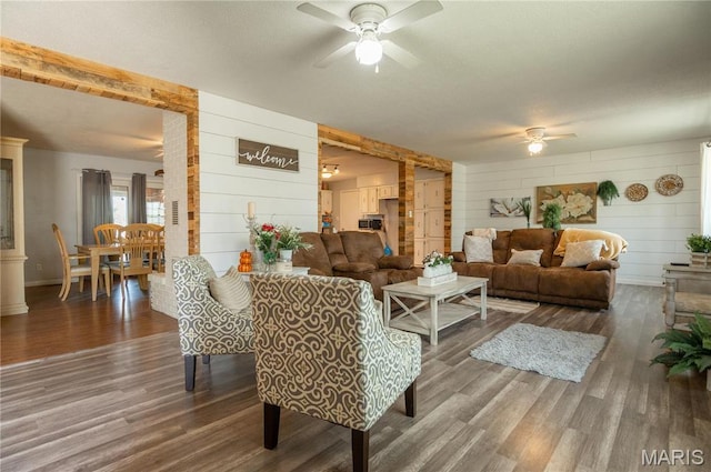 121 Ripley 142e-18, Doniphan, MO 63935 - living area featuring ceiling fan, wood finished floors, wood walls, and baseboards