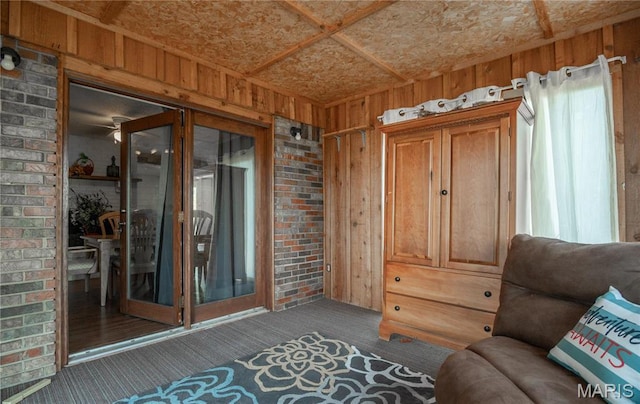121 Ripley 142e-18, Doniphan, MO 63935 - sitting room with carpet flooring, wooden walls, and brick wall