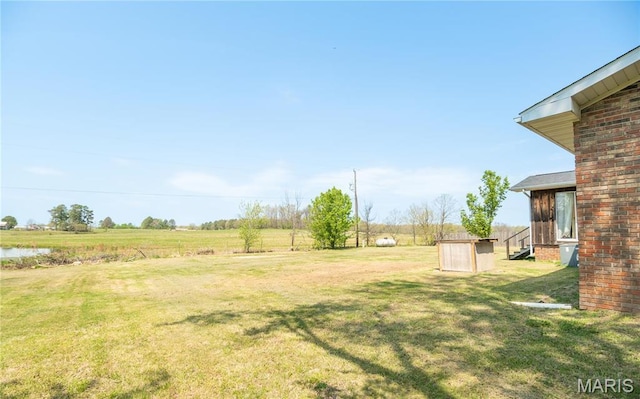 121 Ripley 142e-18, Doniphan, MO 63935 - view of green lawn with a storage unit, an outbuilding, and a view of countryside