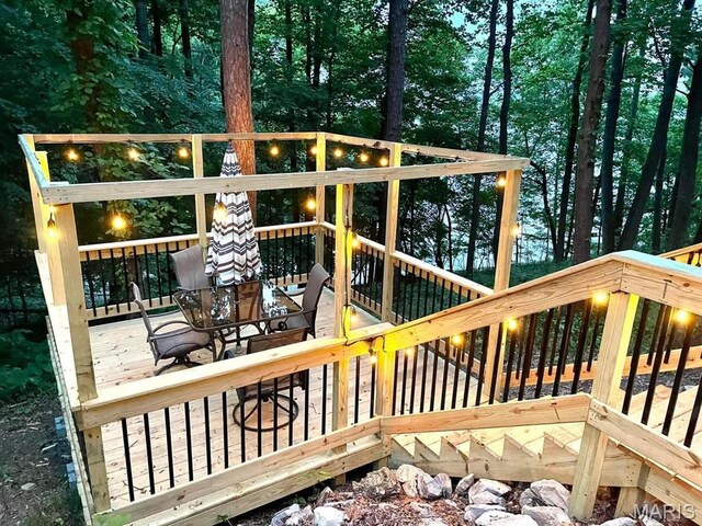 wooden deck featuring outdoor dining space
