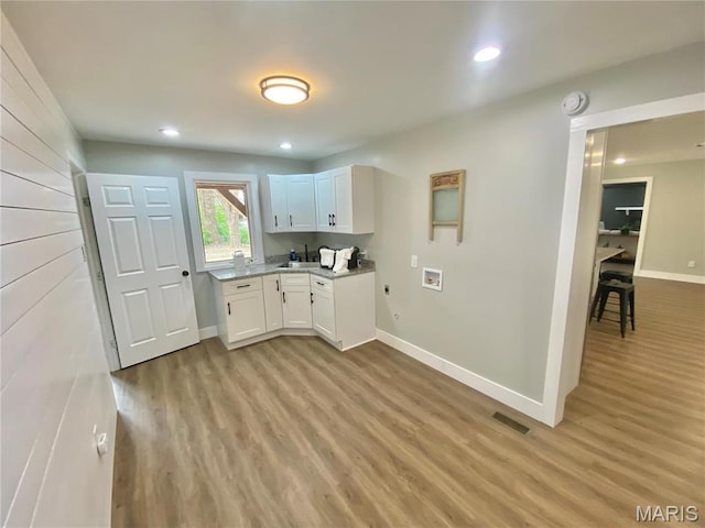 2344 Arnold Dr, Granite City, IL 62040 - kitchen with light wood finished floors, white cabinets, baseboards, light countertops, and recessed lighting