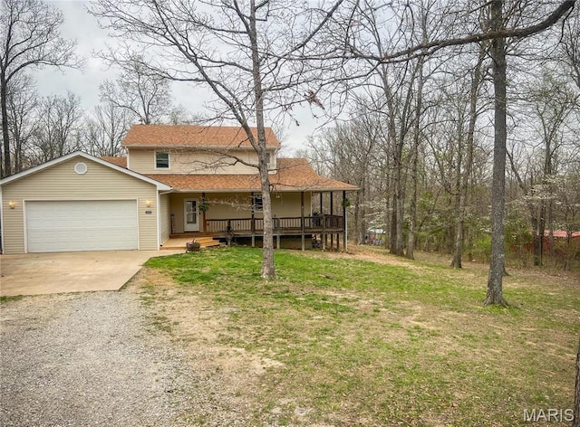 view of front of home with gravel driveway, covered porch, an attached garage, a front yard, and roof with shingles