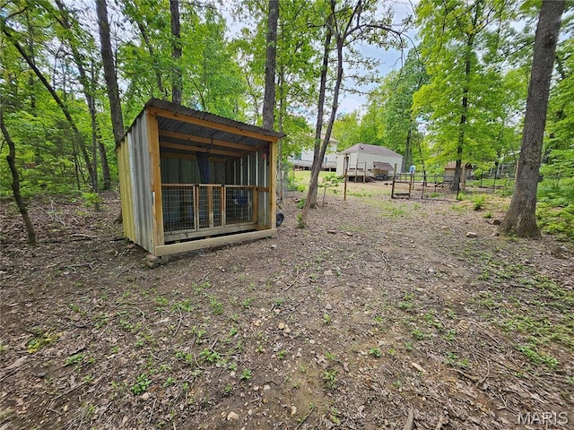 view of yard with an outbuilding, exterior structure, and fence