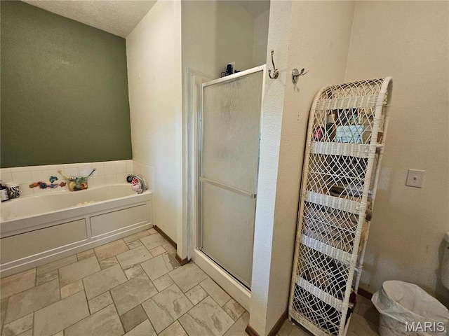 full bathroom with a stall shower and a bath