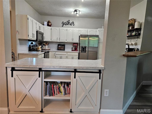 kitchen with stainless steel appliances, open shelves, backsplash, light countertops, and a textured ceiling