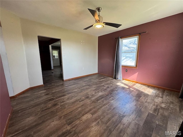 716 Kimball St, Baring, MO 63537 - empty room featuring a ceiling fan, dark wood-type flooring, and baseboards