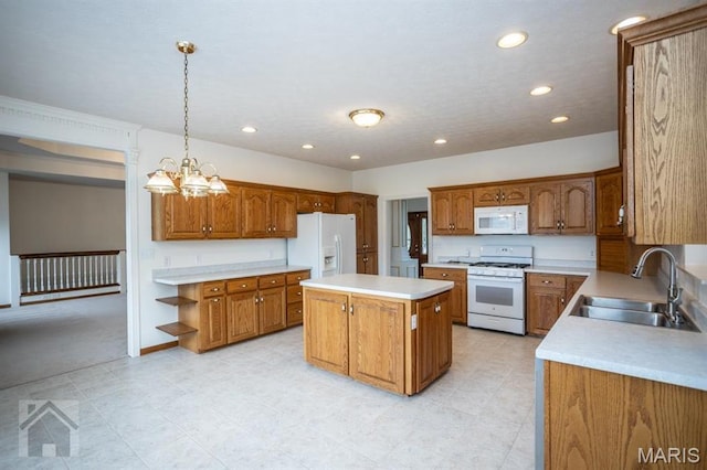 220 April Dr, Saint Robert, MO 65584 - kitchen featuring white appliances, a sink, a center island, brown cabinetry, and recessed lighting