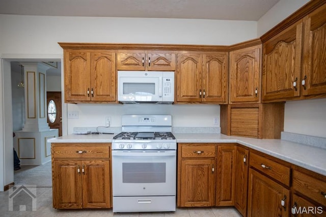 220 April Dr, Saint Robert, MO 65584 - kitchen featuring white appliances, brown cabinets, and light countertops