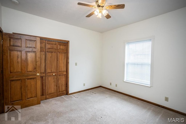 220 April Dr, Saint Robert, MO 65584 - unfurnished bedroom with light colored carpet, baseboards, and a ceiling fan