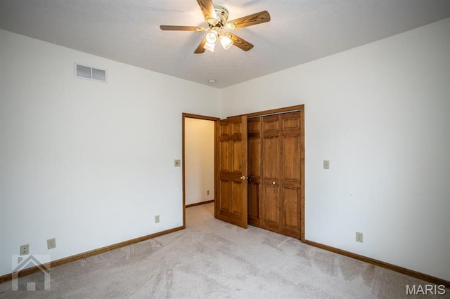 220 April Dr, Saint Robert, MO 65584 - unfurnished bedroom with light carpet, baseboards, a closet, and ceiling fan