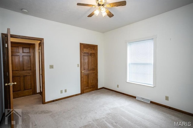 220 April Dr, Saint Robert, MO 65584 - unfurnished bedroom featuring carpet, baseboards, and a ceiling fan