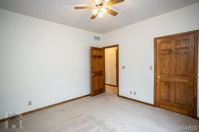 220 April Dr, Saint Robert, MO 65584 - spare room featuring ceiling fan, light colored carpet, and baseboards