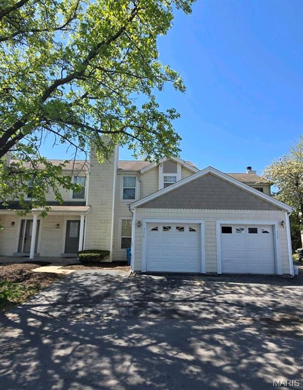 352 Sturbridge Village Dr, Hazelwood, MO 63042 - view of front of house with a detached garage and a chimney