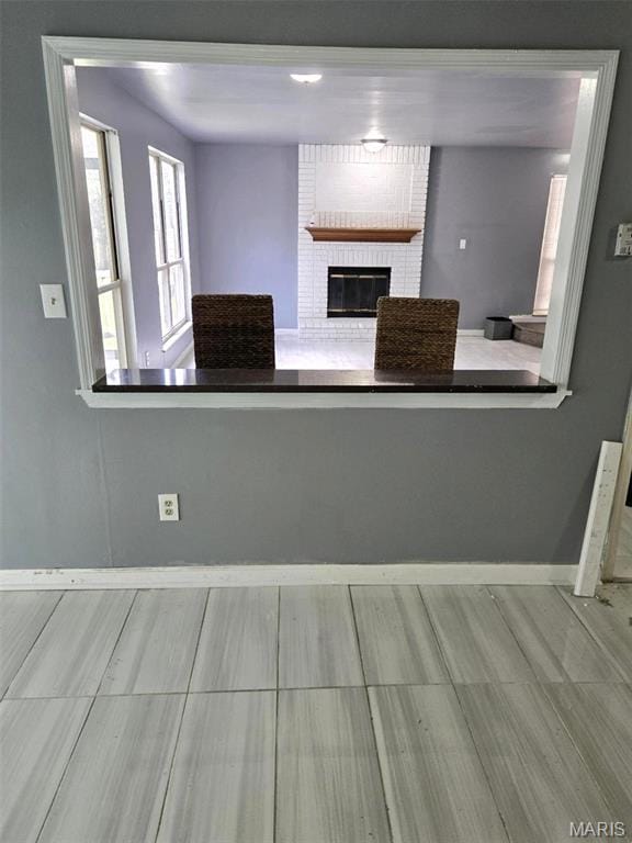 352 Sturbridge Village Dr, Hazelwood, MO 63042 - kitchen featuring a brick fireplace and baseboards