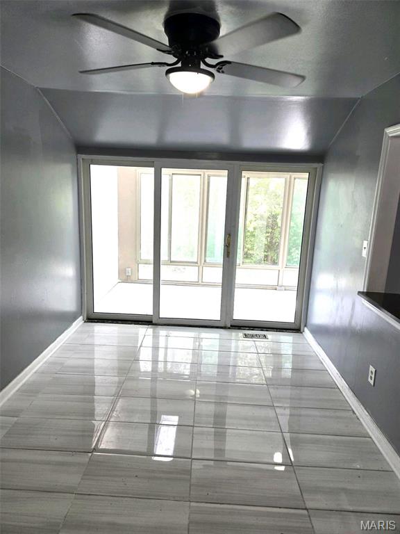 352 Sturbridge Village Dr, Hazelwood, MO 63042 - unfurnished room featuring baseboards, ceiling fan, and vaulted ceiling