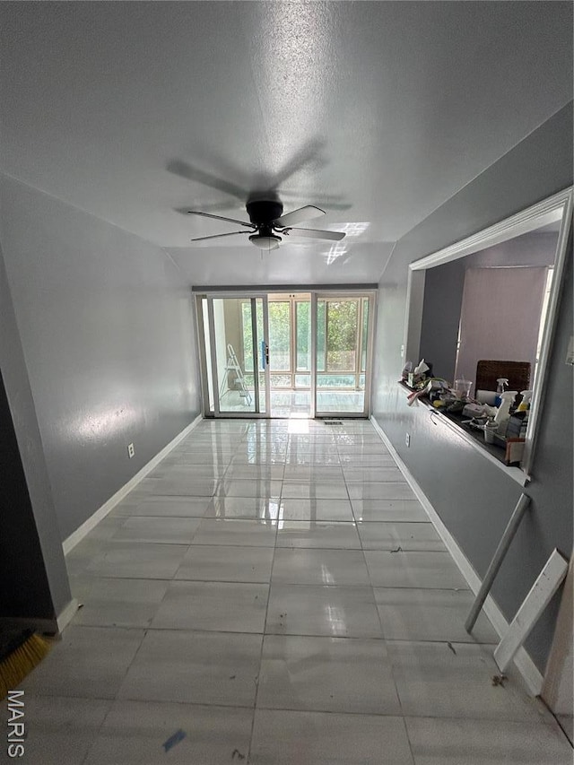 352 Sturbridge Village Dr, Hazelwood, MO 63042 - unfurnished living room with a ceiling fan and baseboards