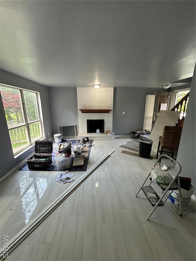 352 Sturbridge Village Dr, Hazelwood, MO 63042 - living area with a brick fireplace and baseboards